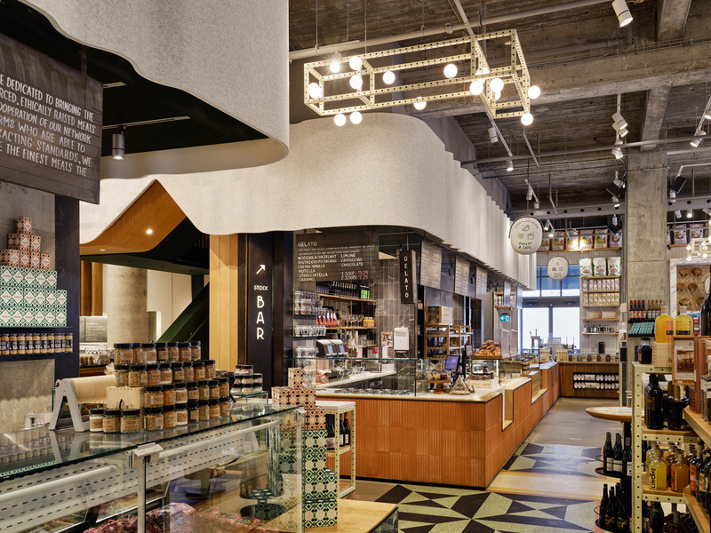 STOCK T.C’s ground floor open market is organized under an embracing, wool felt proscenium that aligns with the bakery and the butchery counters. Terrazzo patches of the original postal hall floor were ground and polished to almost new condition.
Photo credit: Doublespace