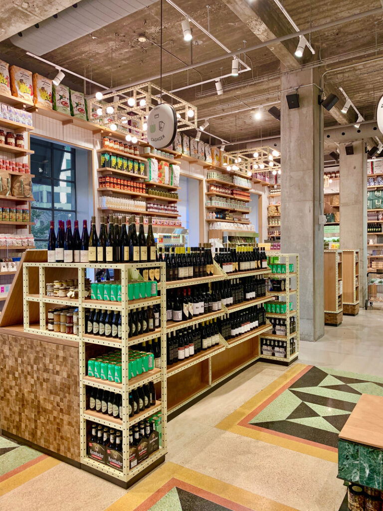 The raw and exposed building’s concrete shell is layered with contemporary elements: custom-designed end-grain wood block counters and butter-yellow extrusions shelving and light fixtures that trace the long gone but remembered ceiling coffers.
Photo credit: Stephanie Palmer