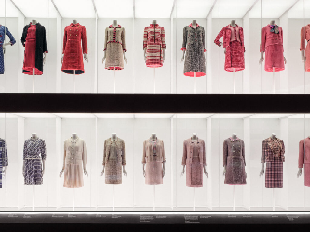 The double-height vitrine is lined in a soft white fabric, with the lighting adding a dynamic luminosity