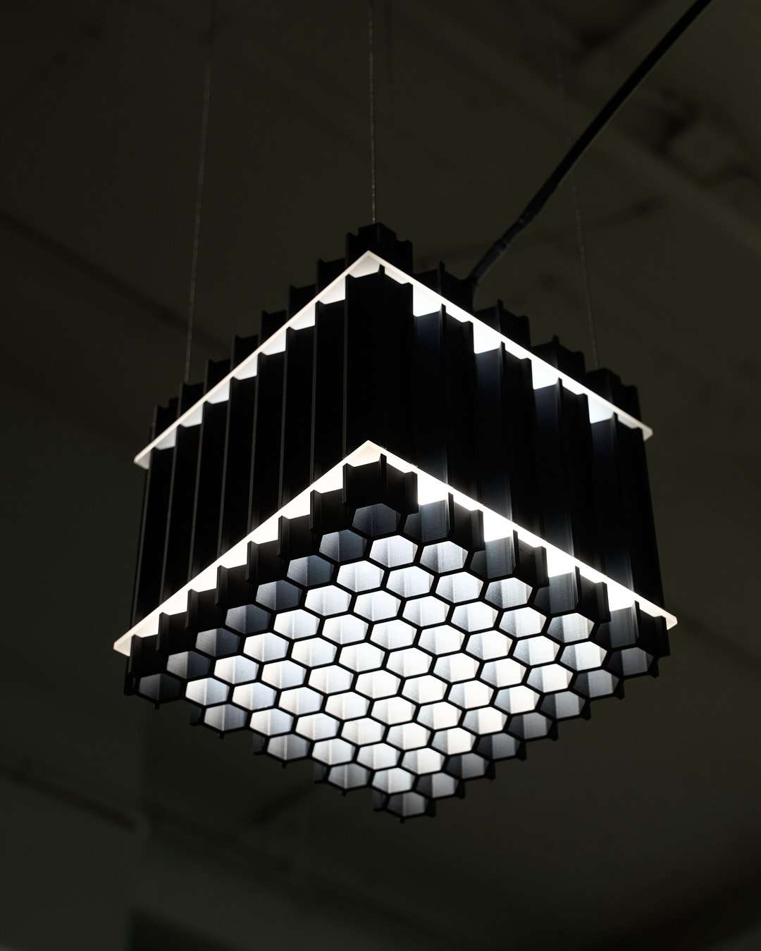 The fusion of art, design, and light takes on a bold form in Grid Extrusion, a collaboration between two visionary artists, Juliana Campos and Aster Verrier. Inspired by the complexities of machinery and the directional qualities of light, this striking piece embraces a raw, industrial aesthetic that turns functionality into a work of art.