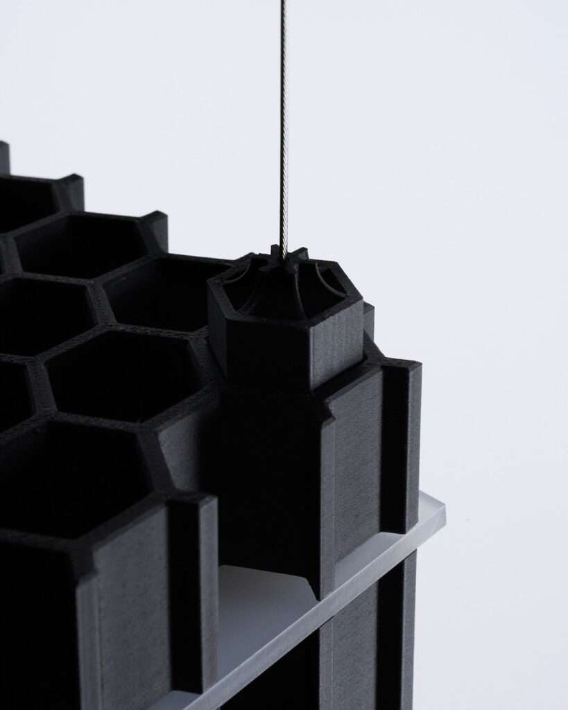 The fusion of art, design, and light takes on a bold form in Grid Extrusion, a collaboration between two visionary artists, Juliana Campos and Aster Verrier. Inspired by the complexities of machinery and the directional qualities of light, this striking piece embraces a raw, industrial aesthetic that turns functionality into a work of art.