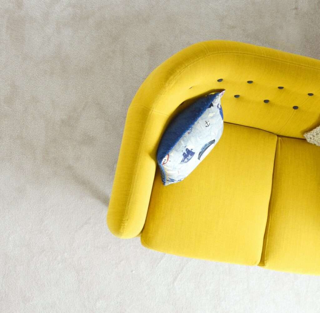 yellow fabric sofa with throw pillow
Photo credit: Christelle Bourgeois