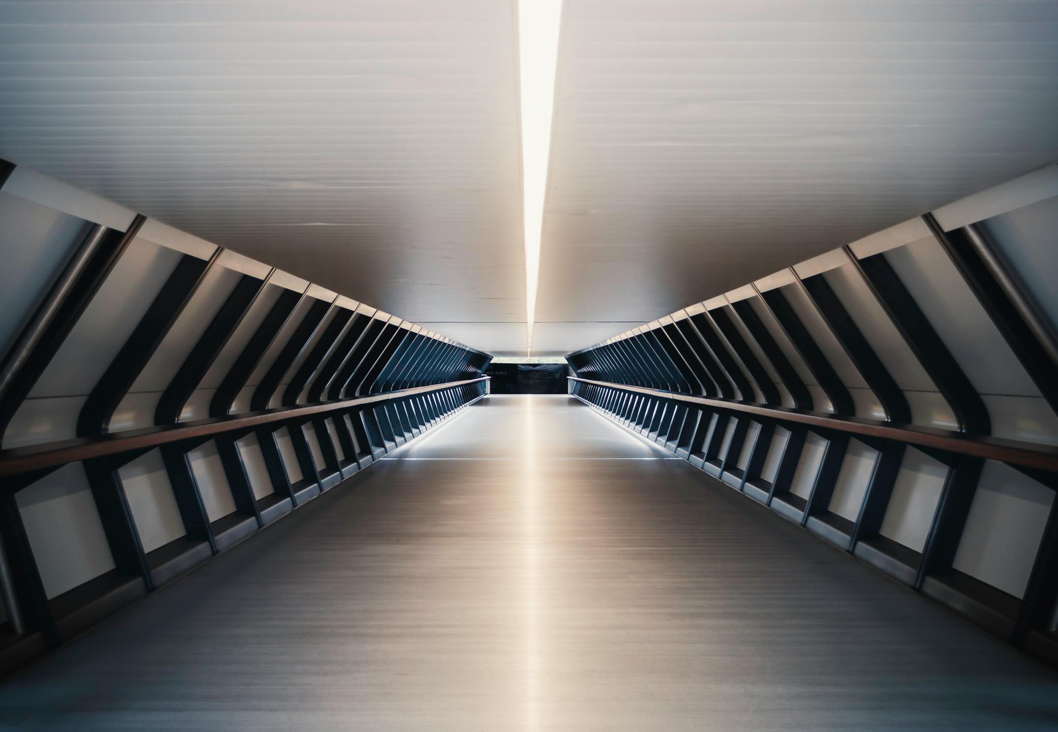 A sleek and futuristic underground tunnel in London, showcasing modern architectural design.
