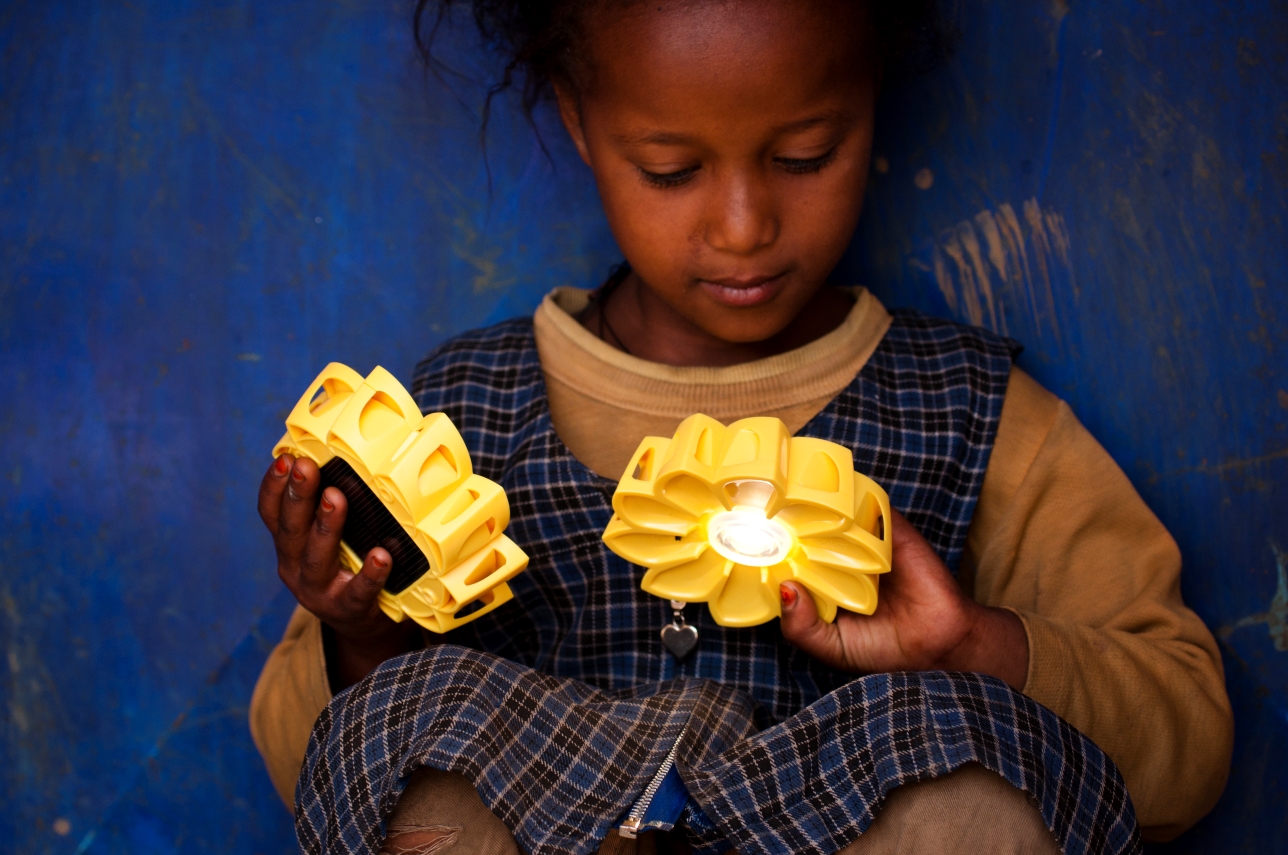 Little girl playing with Little Sun Original in Ethiopia, credit: Merklit Mersha