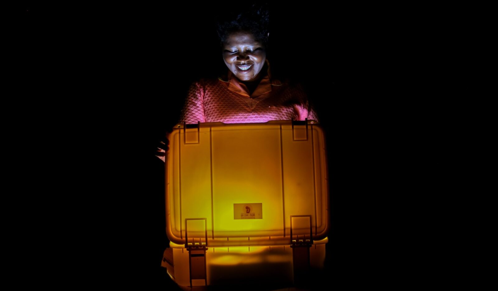Ugandan midwife opening solar suitcase