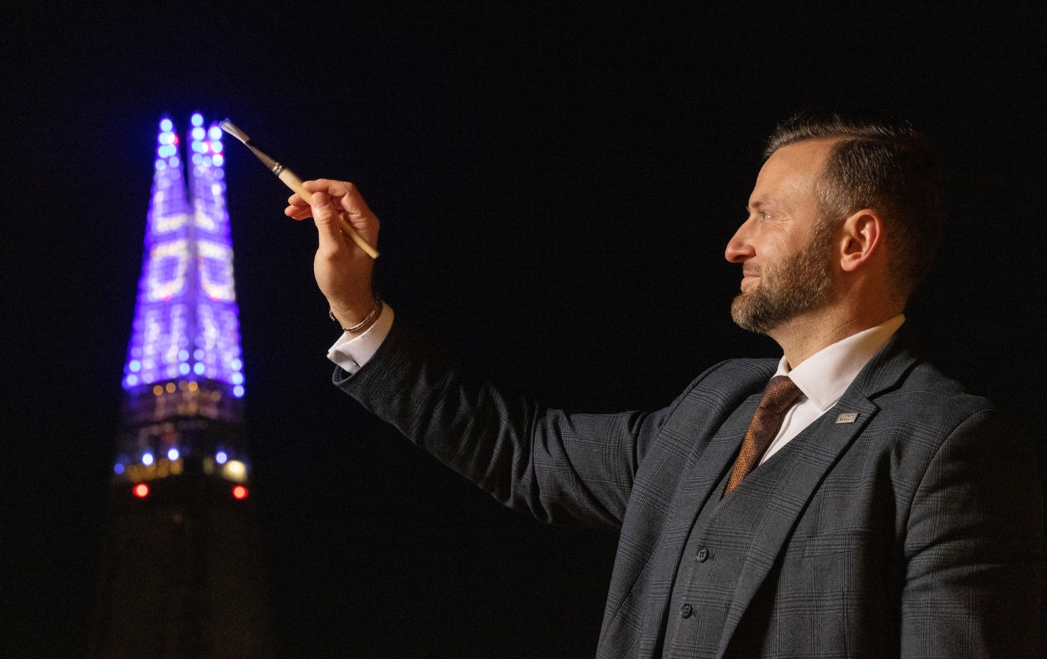 Artist Valdas Dragunas mimes painting The Shard in London at the switch-on of this year’s Christmas light display