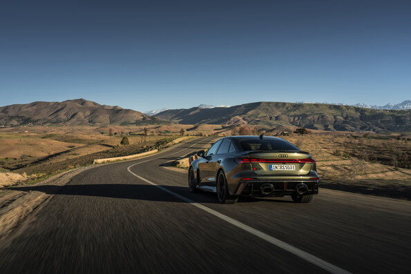 The Audi RS 5 Sedan in Bedford green on an open road in the Atlas Mountains: confident acceleration and high stability.