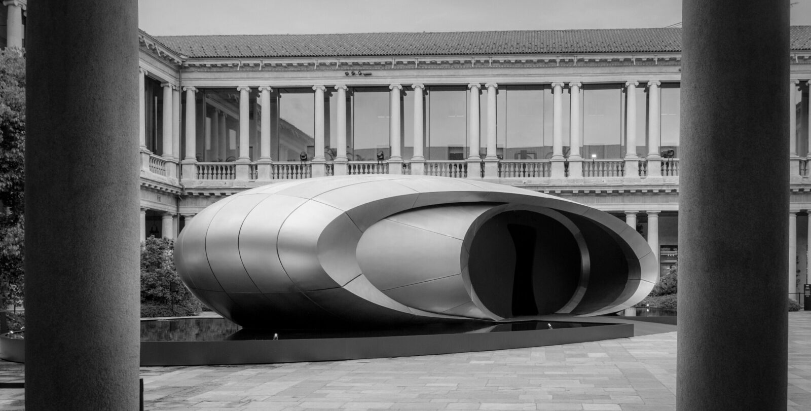 Audis installation Origin in the courtyard of the former Archiepiscopal Seminary in Milan. Developed in collaboration with Zaha Hadid Architects, the sculptural structure translates Audis design philosophy clarity, technical precision and emotion into an architectural spatial installation that forms a deliberate counterpoint to the visual density of the city.