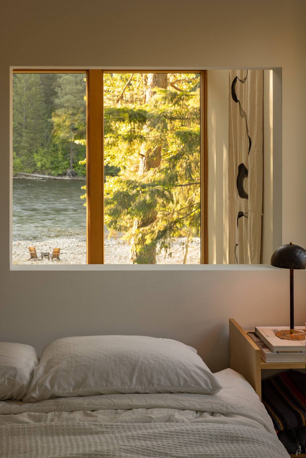 Wenatchee River Cabin by Wittman Estes. View out of the bedroom with bed.