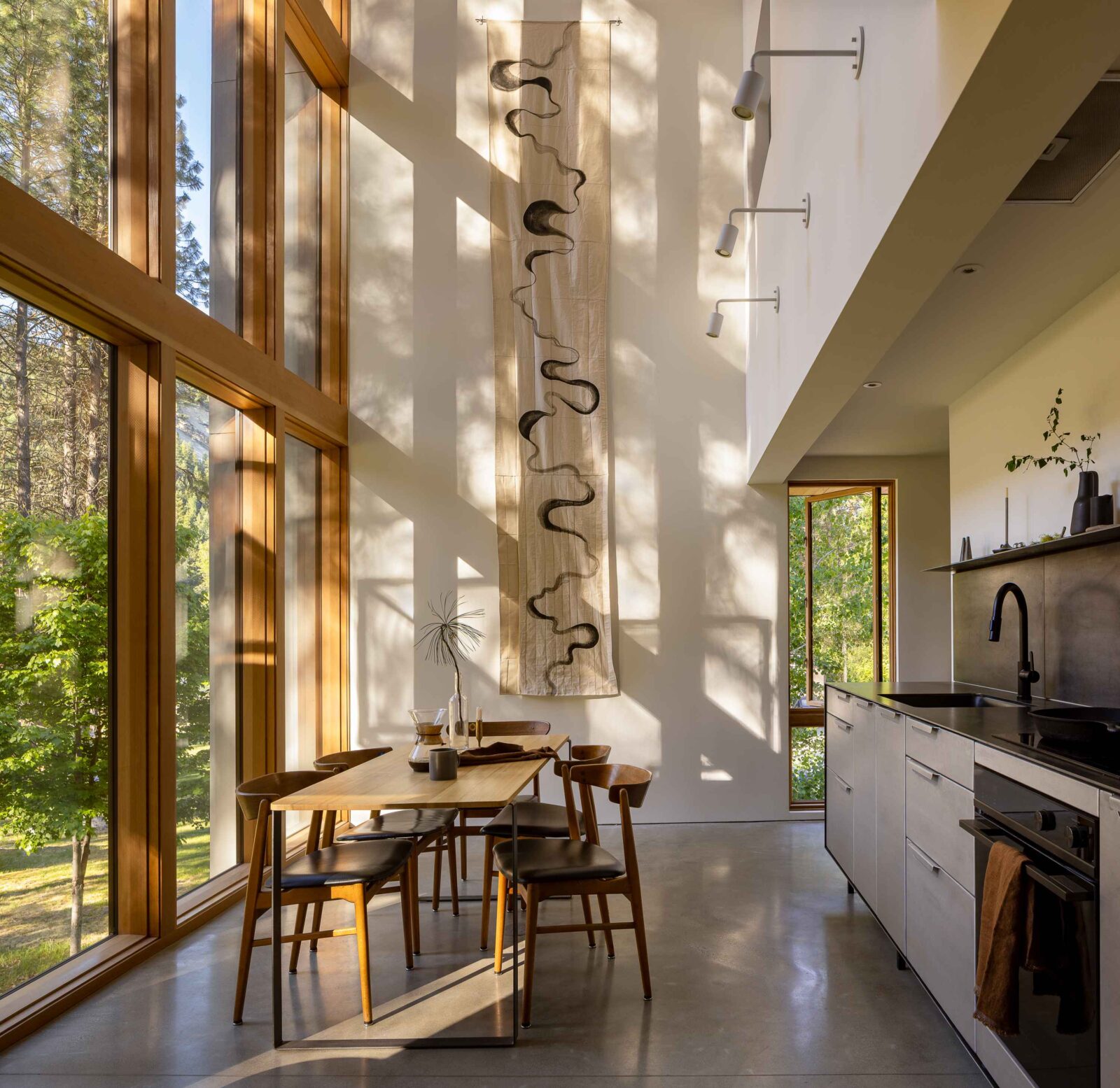 Wenatchee River Cabin by Wittman Estes. Dining table and kitchen.