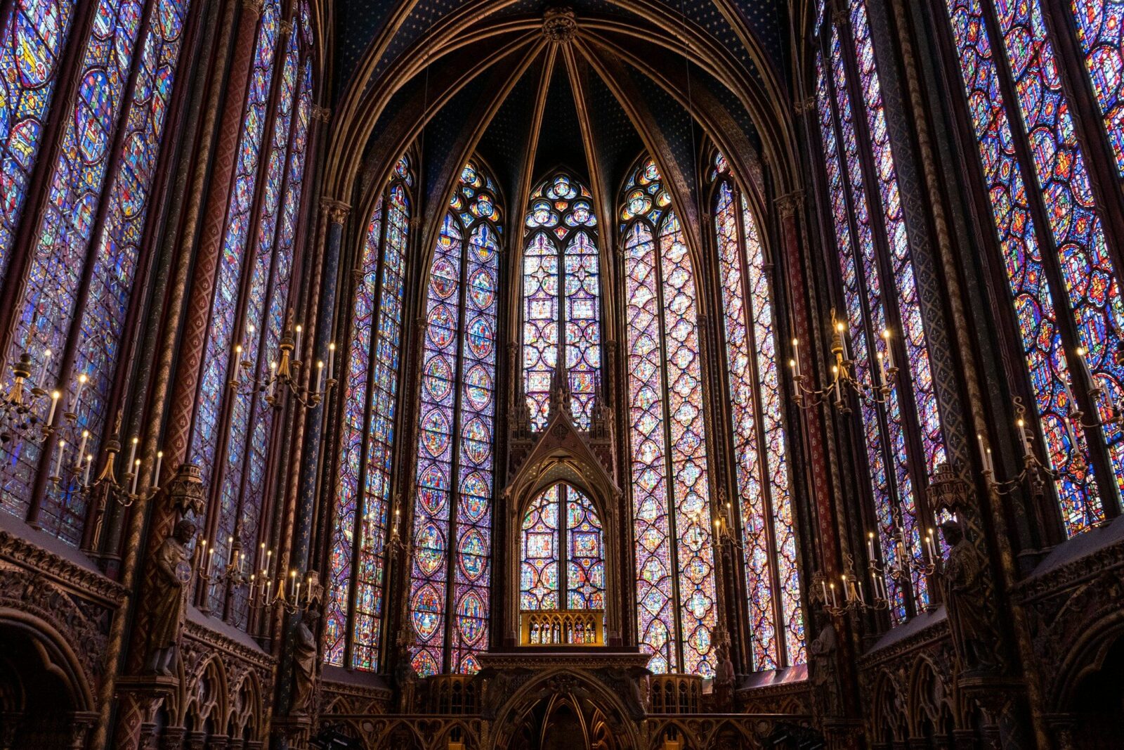 a large cathedral with stained glass windows with Sainte-Chapelle in the background