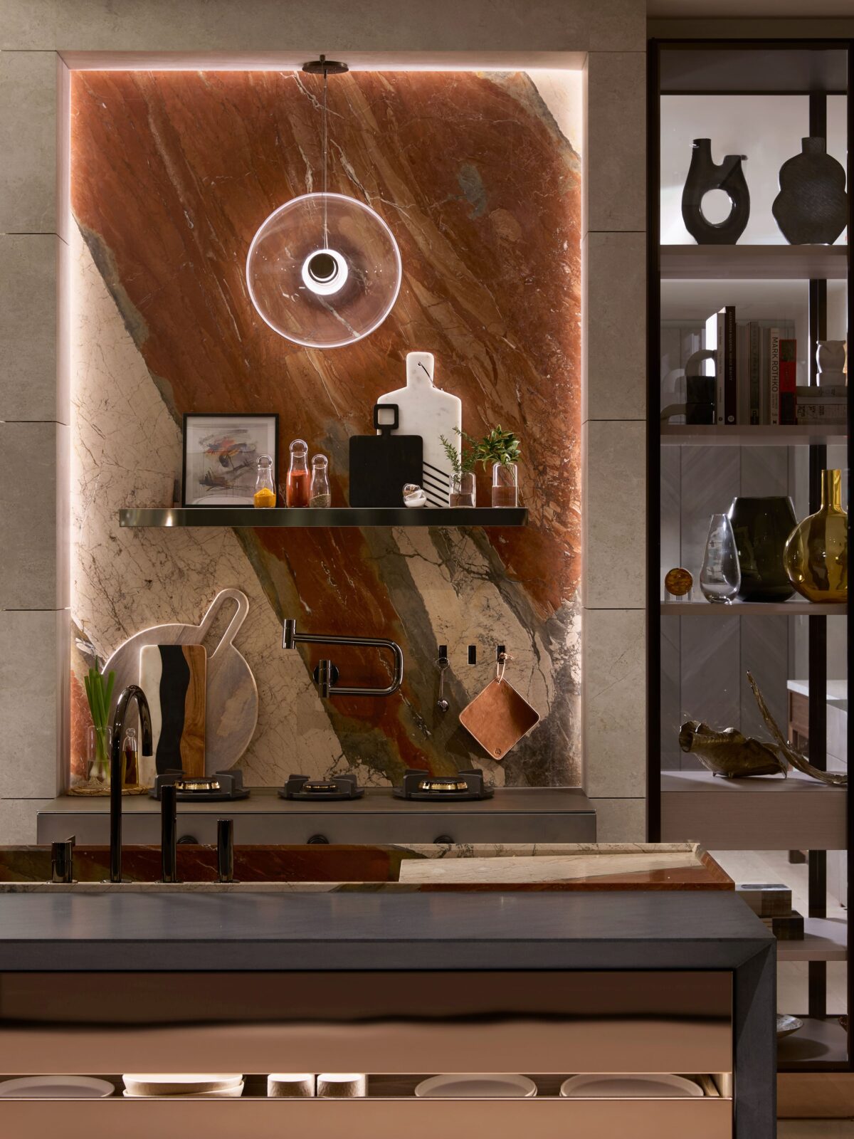 A stone splashback becomes this Cabbonet kitchen’s architectural centrepiece. Designed by Arteim